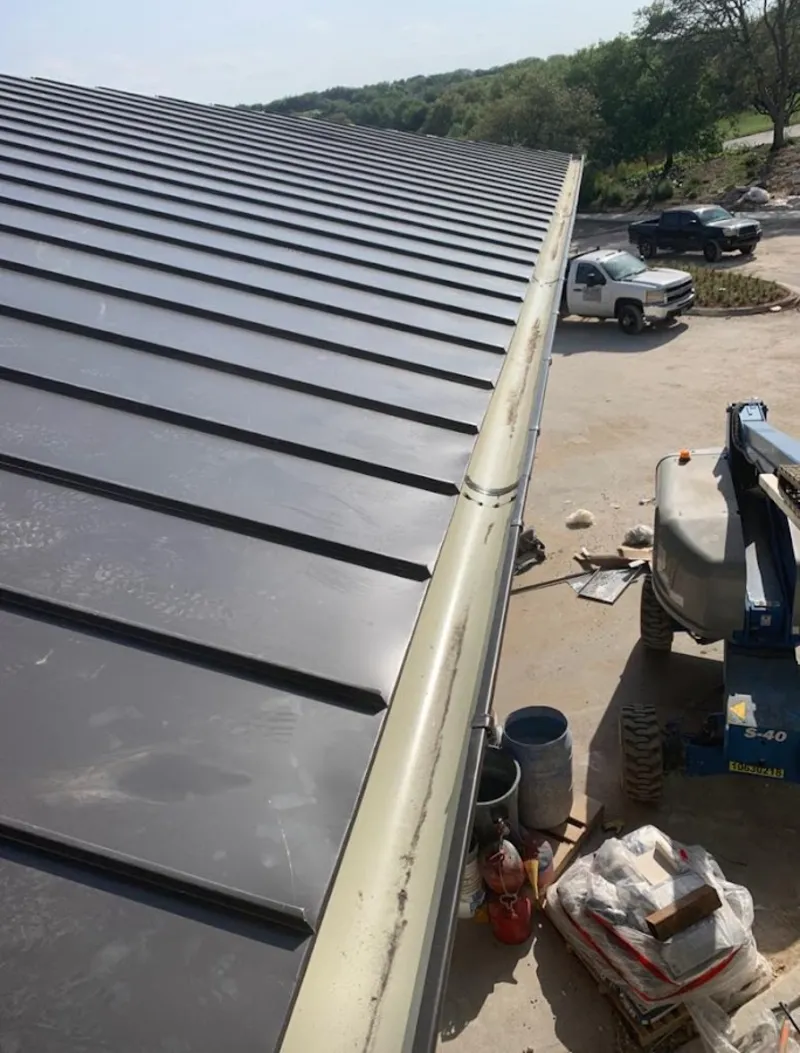 Standing seam panel and gutter detail on a metal roofing jobsite in Willowbrook